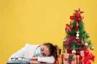 Sleeping girl with Christmas tree background