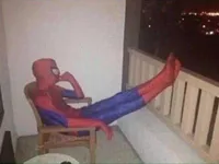 Spider-Man sitting outside